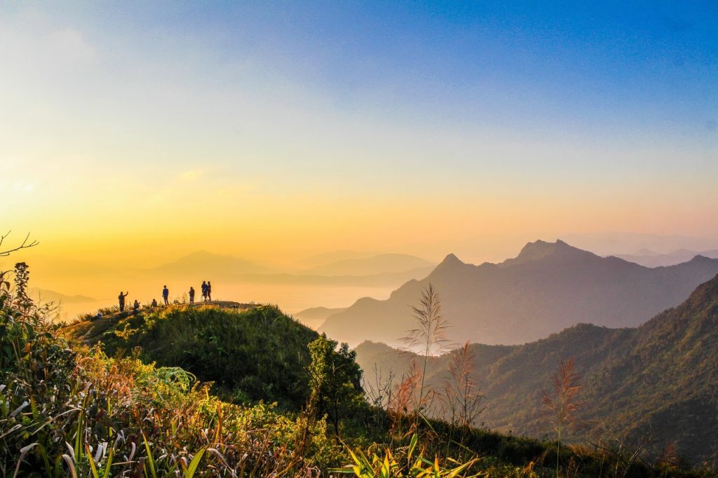 Photo Of People Standing On Top Of Mountain Near Grasses 733162 1024x682 1